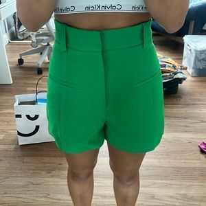 Green shorts with pleats